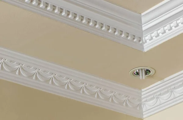 A low angle shot of a modern building\'s ceiling with beige and white colors