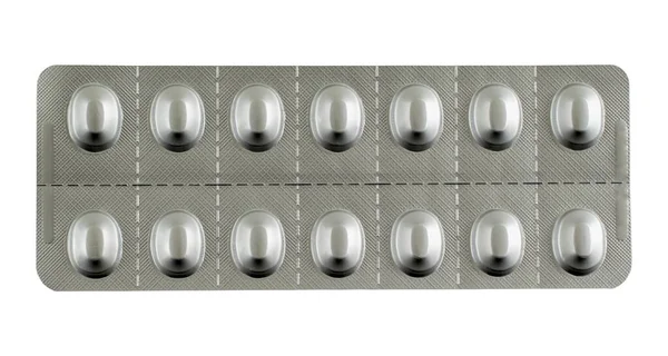 Close Comprimidos Embalados Sob Luzes Isoladas Fundo Branco Conceito Farmacológico — Fotografia de Stock