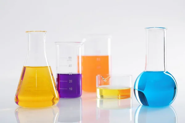 Group Different Flasks Colorful Liquids White Background Lab — Stock Photo, Image