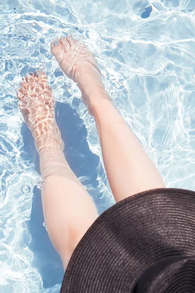 太陽の光のパターンを持つプールの澄んだ水の中に足のトップビュー — ストック写真