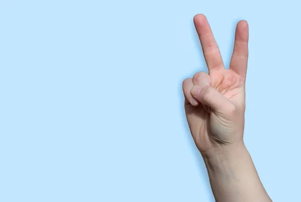 Raised Arm Making Victory Peace Gesture Fingers Light Blue Background Stock Photo
