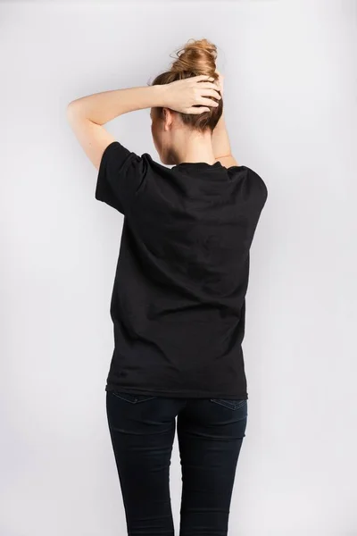 Ung Kvinna Svart Kortärmad Shirt Som Står Mot Vit Vägg — Stockfoto