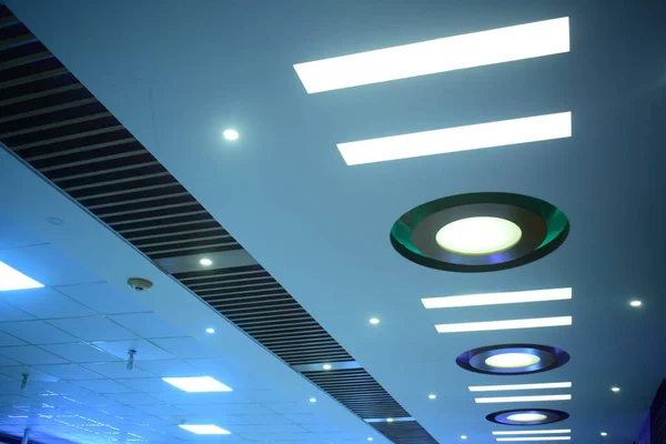 An interior of a roof in linear and circular pattern with blue light