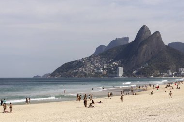 RIO DE JANEIRO, BRAZIL - Jul 12, 2020: Ipanema and Leblon beach in Rio de Janeiro during COVID-19 coronavirus outbreak with city mountains of Gavea and Two Brothers in the background clipart