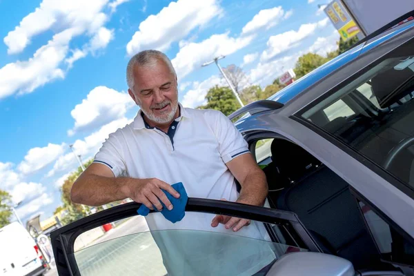 Tiro Ángulo Bajo Viejo Macho Sonriente Limpiando Coche Gris Bajo —  Fotos de Stock