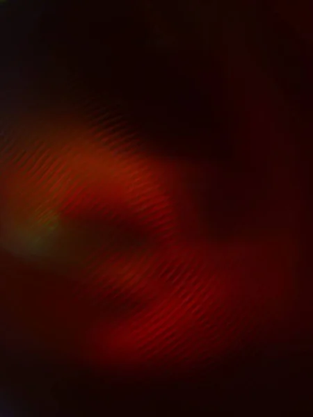 カラフルな光のビームと斑状の回転抽象的な背景 — ストック写真