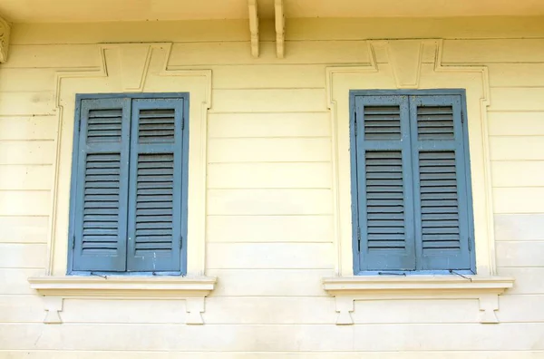 Two Windows Blue Wooden Blinds Yellow Building — Stock Photo, Image