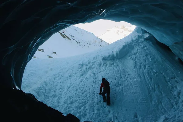 Μια Σιλουέτα Ενός Νεαρού Που Περπατούσε Μια Σπηλιά Χειμώνα — Φωτογραφία Αρχείου