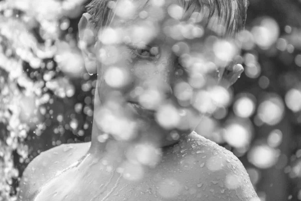 庭で水遊びして楽しい若い白人の少年の美しいグレースケールのショット — ストック写真