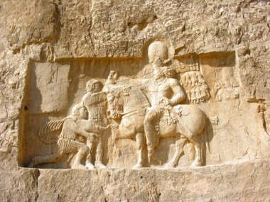 A stone carving in bas-relief on the Tomb of Darius the Great at Persepolis, Iran clipart