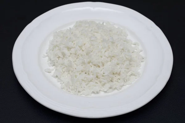 Closeup Shot Rice White Plate Black Surface — Stock Photo, Image