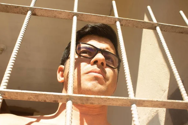 Closeup Portrait Young Hispanic Man Wearing Eyeglasses Looking Balcony Bars — Stock Photo, Image