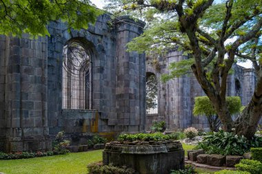 The Santiago Apostol Parish Ruins in the city of Cartago, Costa Rica, a cultural heritage site, with lush trees and greenery. clipart