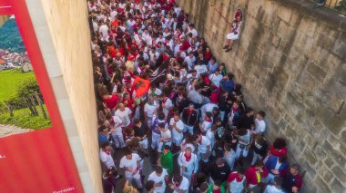 PAMPLONA, SPAIN - Jul 07, 2019: San Fermin. People in Pamplona,Spain during the Running of the bulls  . clipart