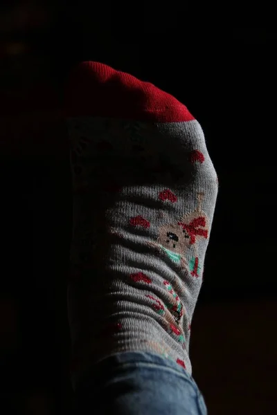 Vertical Closeup Shot Foot Christmas Sock Darkness — Stock Photo, Image