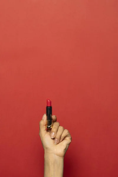 Vertical Shot Hand Holding Lipstick Isolated Red Background — Stock Photo, Image