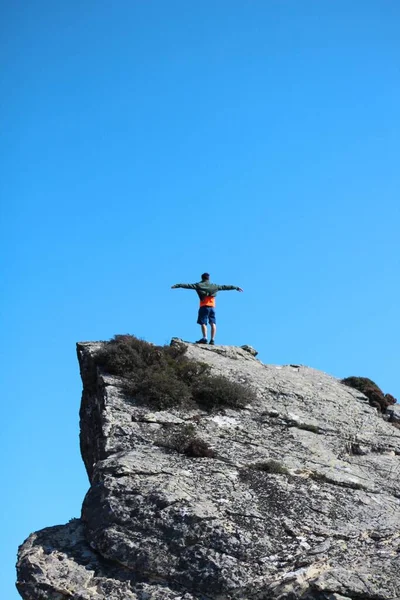 Vertical Shot Young Man Standing Top Mountain Outstretched Arms Concept — Stock Photo, Image