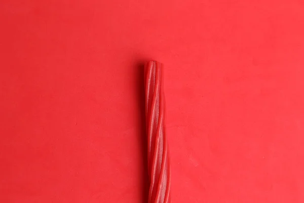 Top View Single Piece Red Licorice Red Background — Stock Photo, Image