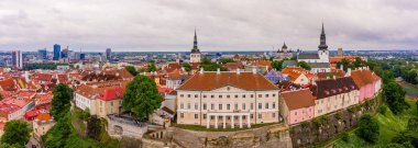 An aerial shot of the old town of Tallinn with orange roofs, churches' spires and the Toompea castle clipart
