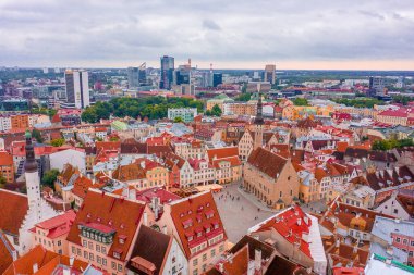 An aerial shot of the old town of Tallinn with orange roofs, churches' spires and narrow streets clipart