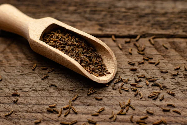 stock image A closeup shot of caraway seeds in a wooden spoon on a wooden surface