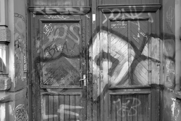 Grayscale Shot Graffiti Wooden Entrance Doors — Stock Photo, Image