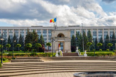 The Triumphal Arch of Chisinau and the Government house under the sunlight in Moldova clipart