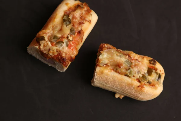一个用融化的奶酪切成两半的美味脆热狗的特写镜头 — 图库照片