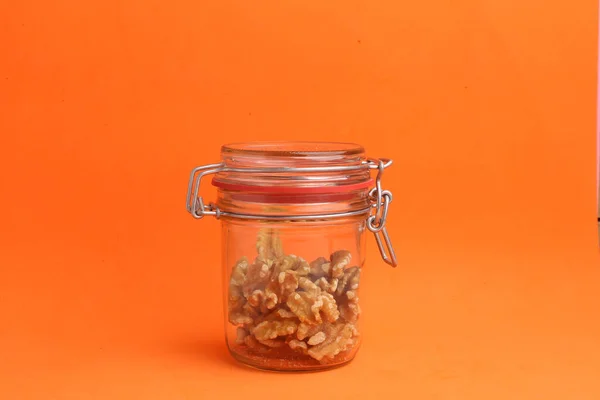 Closeup Shot Nuts Jar Orange Background — Stock Photo, Image
