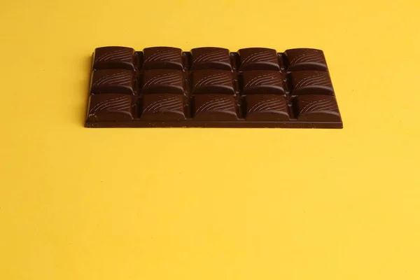 モノクロの背景にダークチョコレートバーの高角度ショット — ストック写真