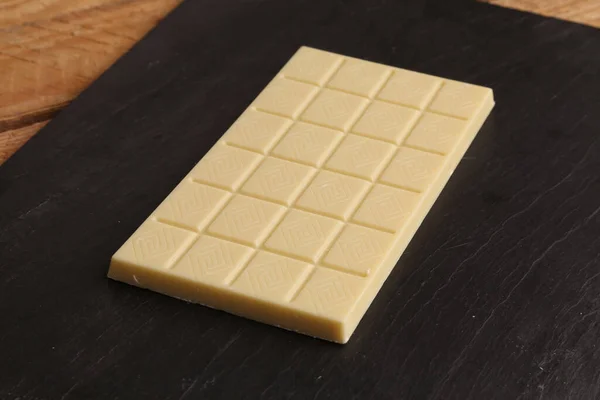 Gros Plan Une Barre Chocolat Blanche Entière Sur Plateau Noir — Photo