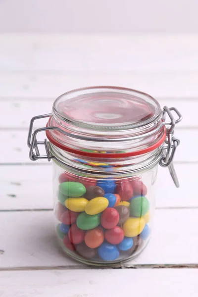 Vertical Shot Glass Jar Colorful Candies Wooden Background — Stock Photo, Image