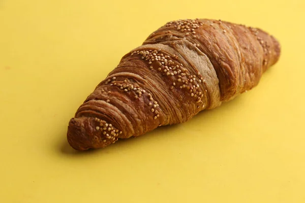 Closeup Shot Delicious Croissant Yellow Background — Stock Photo, Image