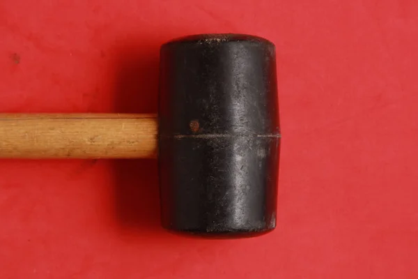 A rubber mallet isolated on red background