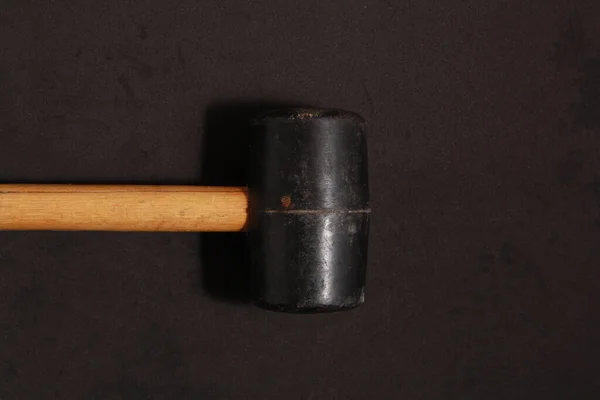 A top view of a rubber mallet isolated on a black background