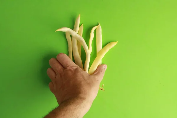 Male Hand Putting Yellow Asparagus Beans Green Surface — Stock Photo, Image