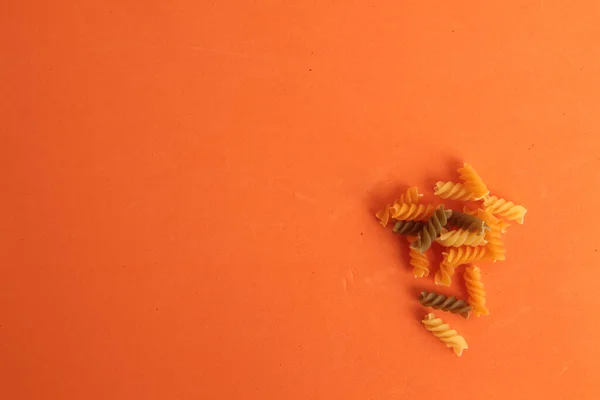 Верхний Вид Цветной Сырой Спиральной Пасты Оранжевом Фоне — стоковое фото