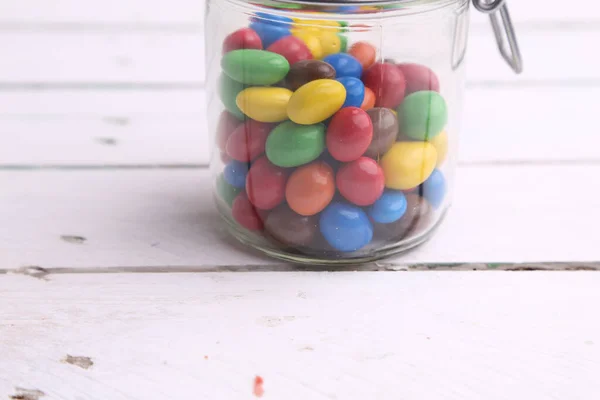 Macro Shot Colorful Chocolate Balls Stuffed Peanuts Glass Jar Wooden — Stock Photo, Image