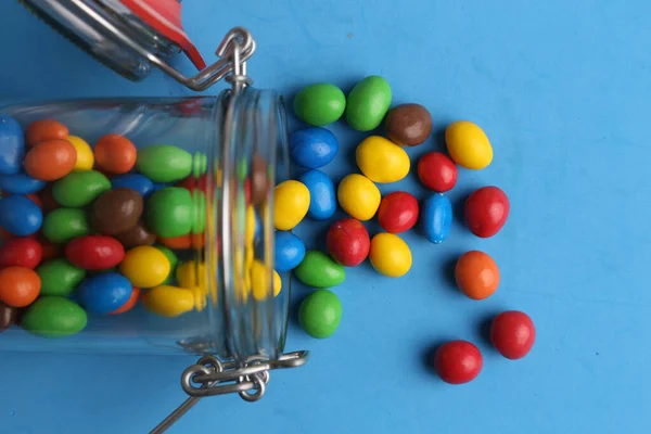 Flat Lay Shot Colorful Candy Balls Falling Out Jar Blue — Stock Photo, Image
