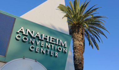ANAHEIM, CA, UNITED STATES - Jul 22, 2019: The beautiful building of the Anaheim Convention Center with palm trees on a sunny day. clipart
