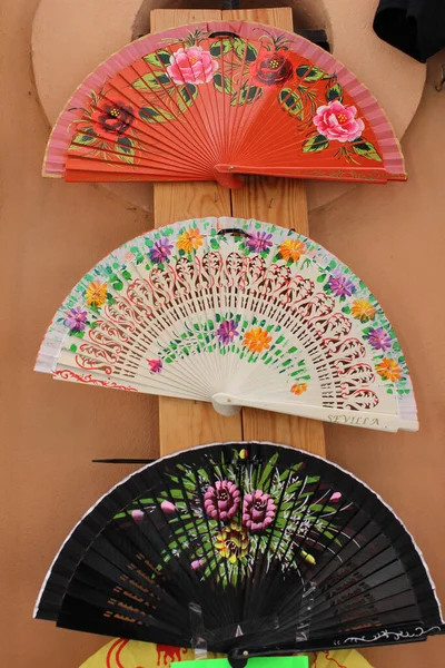 A close up shot of a colorful handheld folding fans
