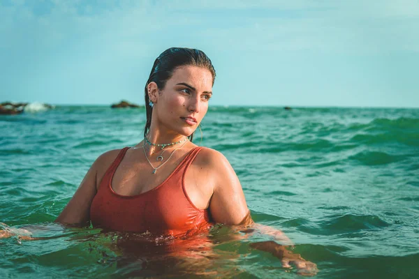 一个漂亮的欧洲女人穿着橙色泳衣在海上玩得很开心 — 图库照片