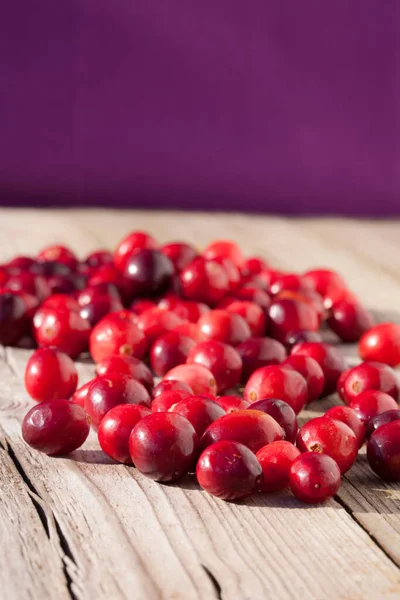 Vertical Closeup Shot Fresh Red Cranberries Wooden Table Purple Background — Stock Photo, Image