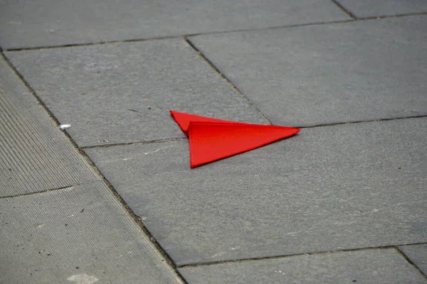 Bright Red Paper Plane Laying Gray Cement Floor — Stock Photo, Image