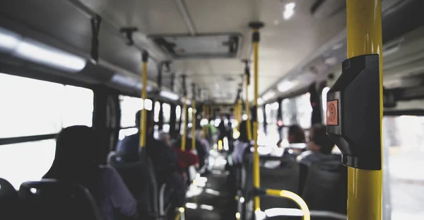 A selective focus shot of a bus with passengers