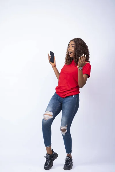 Vertikal Bild Upphetsad Ung Afrikansk Kvinna Som Håller Telefonen Glatt — Stockfoto
