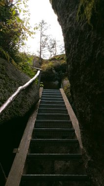 A low angle shot of the stairs in the middle of the Luisenburg Rocky Labyrinth in Fichtelgebirge, Germany clipart