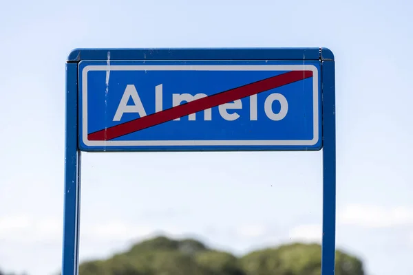 ALMELO, NETHERLANDS - Aug 06, 2020: Traffic sign denoting that you are about to enter a residential area in which speed limits are in place with fluffy clouds in clear sky behind — Stock Image Almelo Netherlands Aug 2020 Traffic Sign Denoting You Enter Residential Royalty Free Stock Images