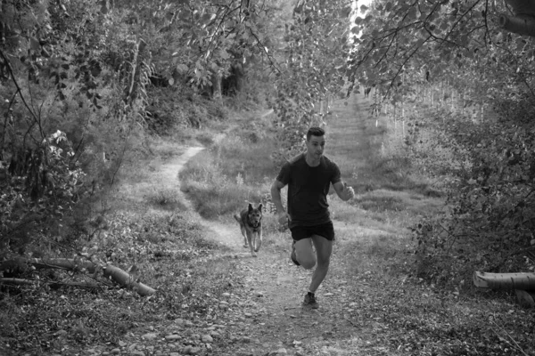 Grayscale Shot Athletic Male Training His Dog — Stock Photo, Image