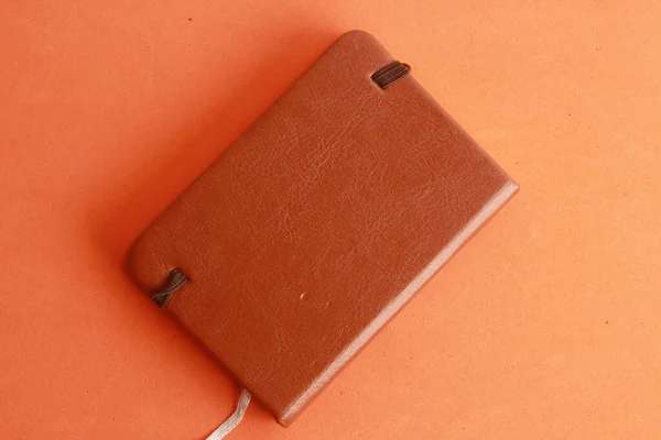 Closed Brown Leather Notebook Orange Background — Stock Photo, Image